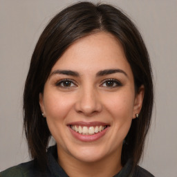 Joyful white young-adult female with medium  brown hair and brown eyes