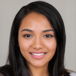 Joyful latino young-adult female with long  black hair and brown eyes
