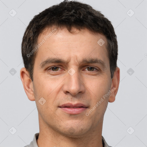 Joyful white adult male with short  brown hair and brown eyes