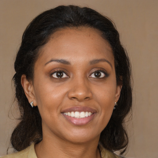 Joyful latino young-adult female with medium  brown hair and brown eyes