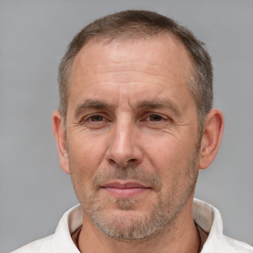 Joyful white middle-aged male with short  brown hair and brown eyes