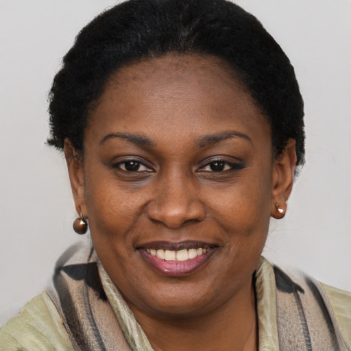 Joyful black adult female with short  brown hair and brown eyes