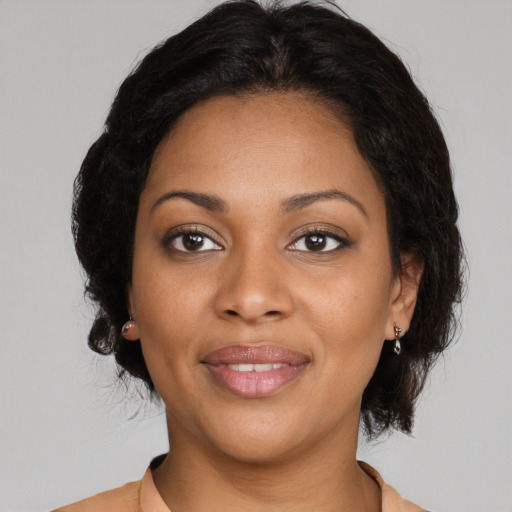 Joyful black young-adult female with medium  brown hair and brown eyes