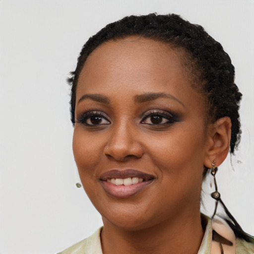 Joyful black young-adult female with short  black hair and brown eyes