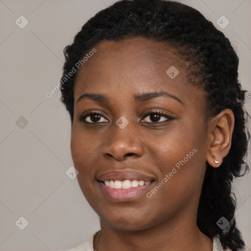 Joyful black young-adult female with medium  black hair and brown eyes