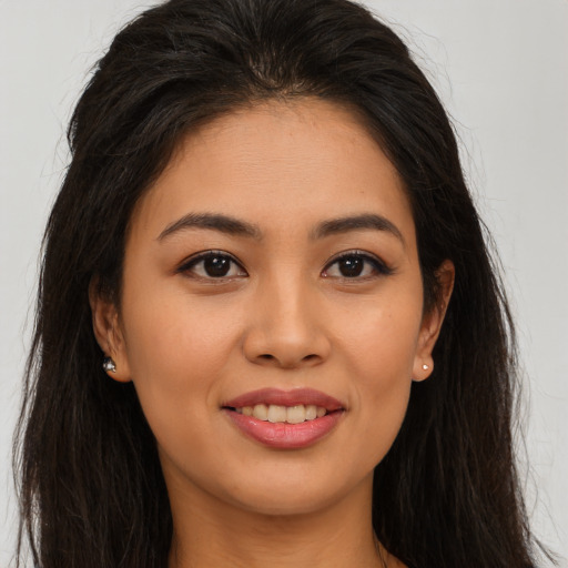 Joyful asian young-adult female with long  brown hair and brown eyes