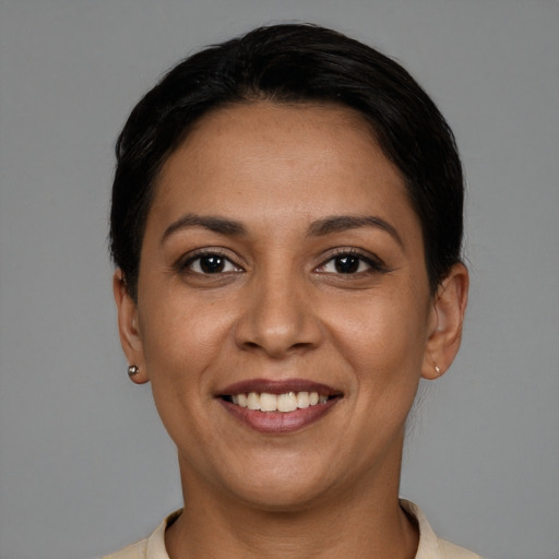 Joyful latino young-adult female with short  brown hair and brown eyes