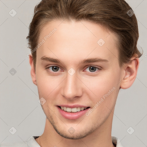 Joyful white young-adult female with short  brown hair and grey eyes