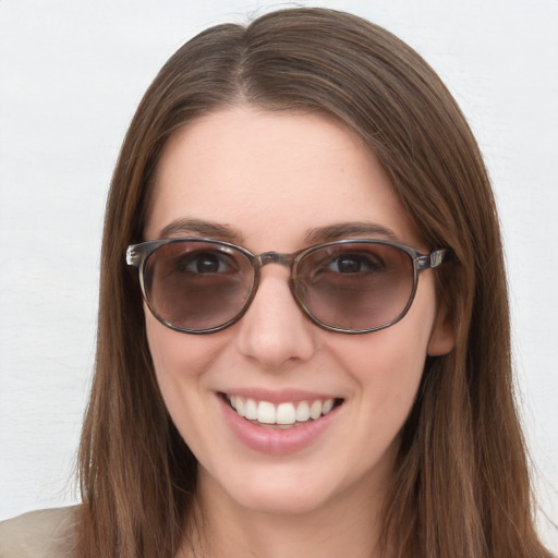 Joyful white young-adult female with long  brown hair and blue eyes