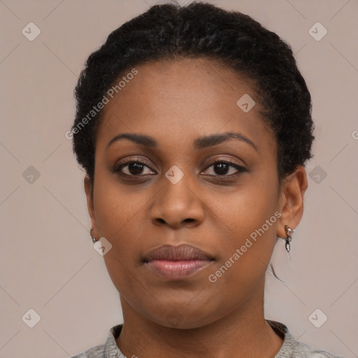 Joyful black young-adult female with short  black hair and brown eyes