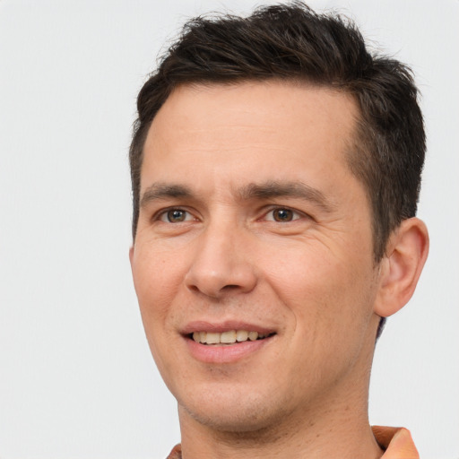 Joyful white adult male with short  brown hair and brown eyes