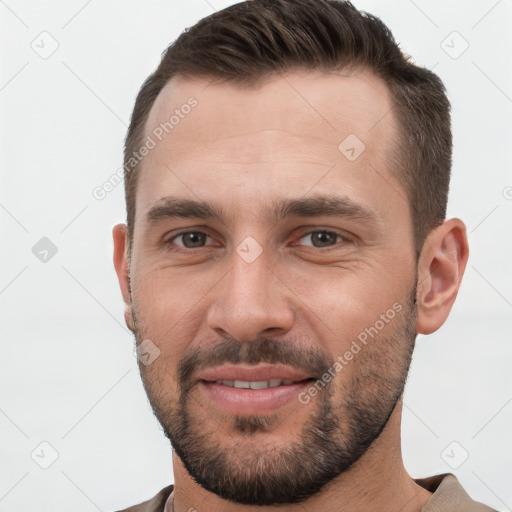 Joyful white young-adult male with short  brown hair and brown eyes