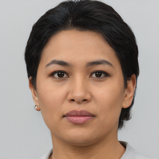 Joyful asian young-adult female with short  black hair and brown eyes