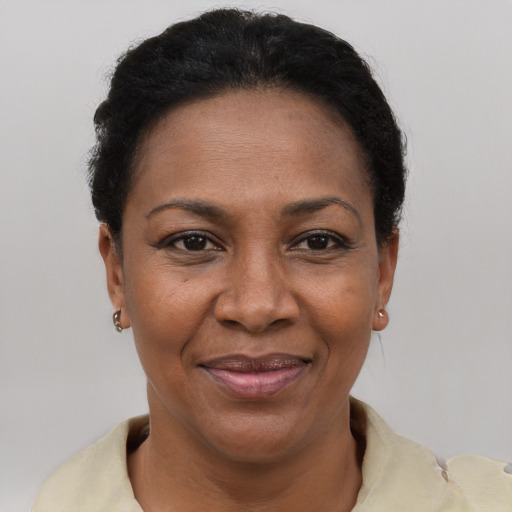 Joyful black adult female with short  black hair and brown eyes