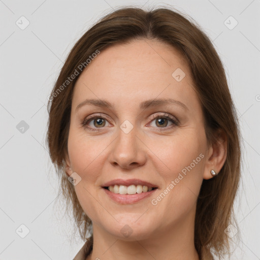 Joyful white adult female with medium  brown hair and grey eyes