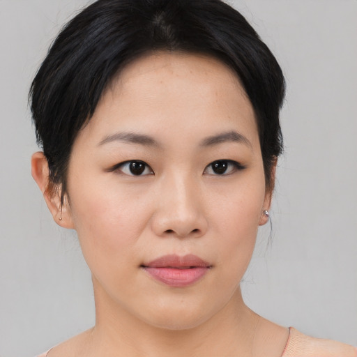 Joyful asian young-adult female with medium  black hair and brown eyes