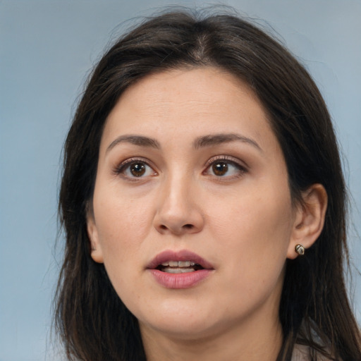 Joyful white young-adult female with long  brown hair and brown eyes