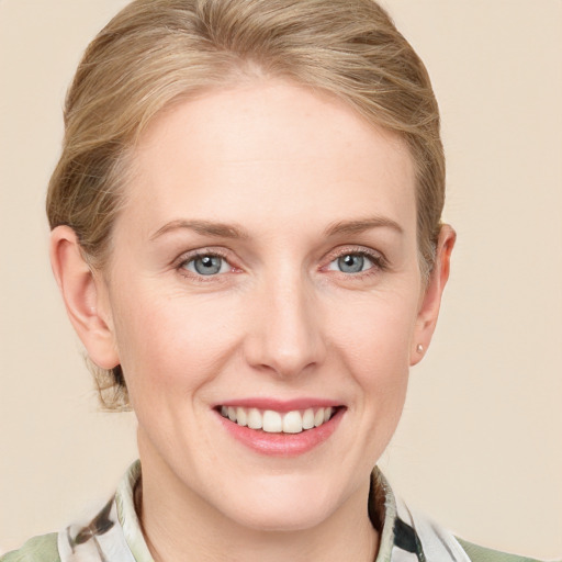 Joyful white young-adult female with medium  brown hair and blue eyes