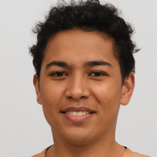 Joyful latino young-adult male with short  brown hair and brown eyes