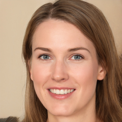 Joyful white young-adult female with long  brown hair and green eyes