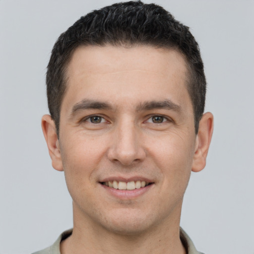 Joyful white young-adult male with short  brown hair and brown eyes