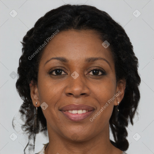 Joyful black adult female with medium  brown hair and brown eyes