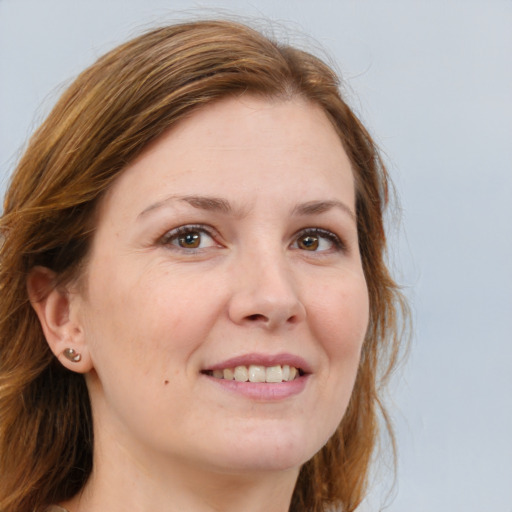 Joyful white adult female with long  brown hair and brown eyes