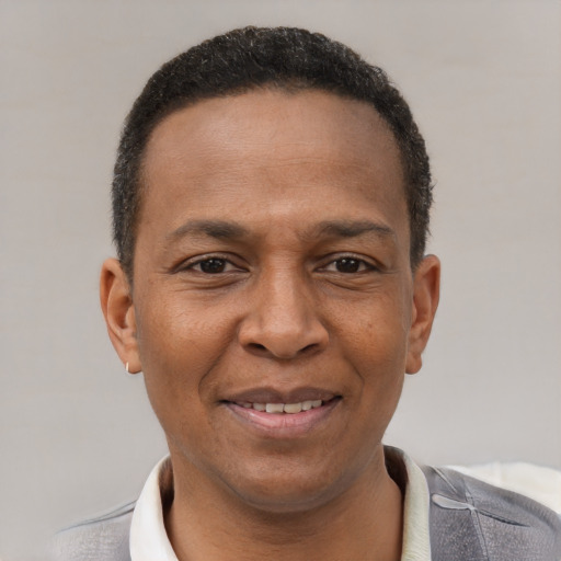 Joyful latino adult male with short  brown hair and brown eyes