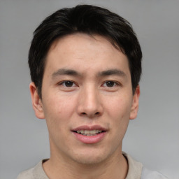 Joyful asian young-adult male with short  brown hair and brown eyes