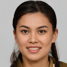 Joyful latino young-adult female with long  brown hair and brown eyes