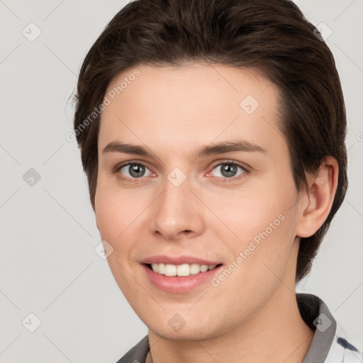 Joyful white young-adult female with short  brown hair and grey eyes