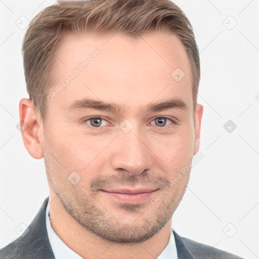 Joyful white young-adult male with short  brown hair and grey eyes