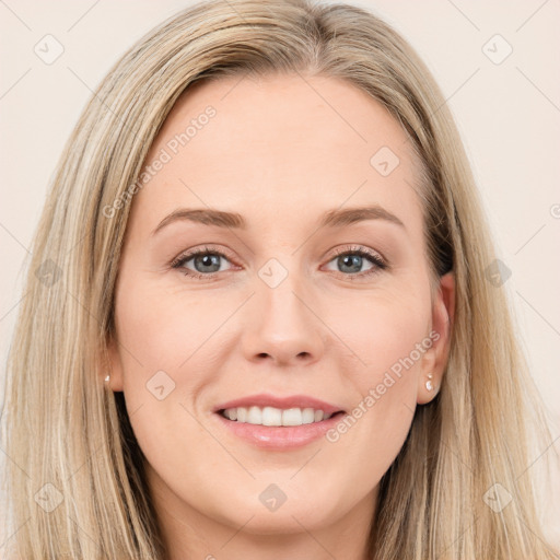 Joyful white young-adult female with long  brown hair and grey eyes