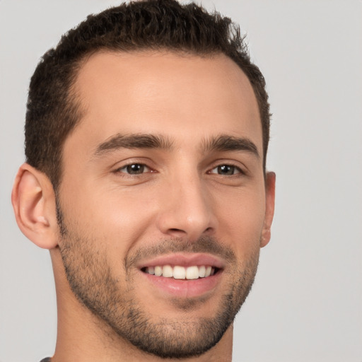 Joyful white young-adult male with short  brown hair and brown eyes