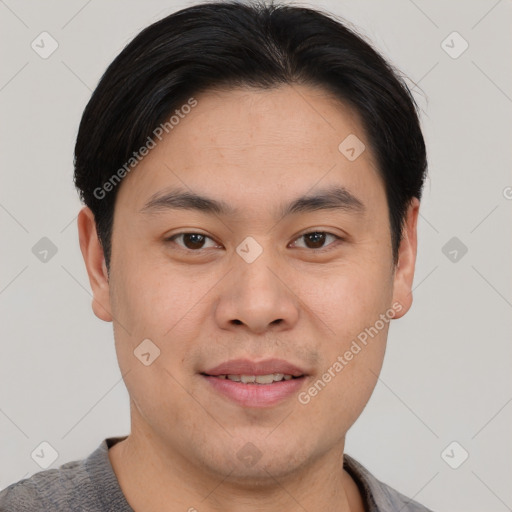 Joyful asian young-adult male with short  brown hair and brown eyes