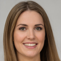 Joyful white young-adult female with long  brown hair and green eyes