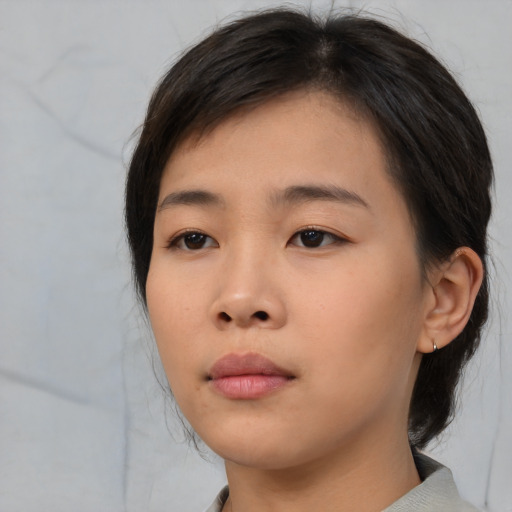 Neutral asian young-adult female with medium  brown hair and brown eyes