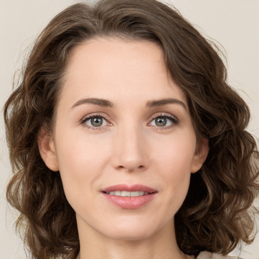 Joyful white young-adult female with long  brown hair and green eyes