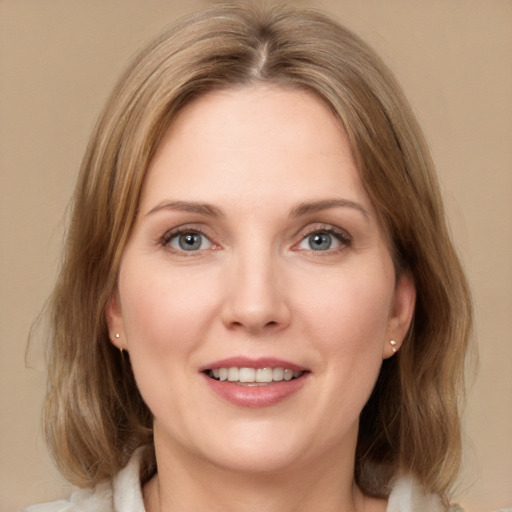 Joyful white young-adult female with medium  brown hair and green eyes