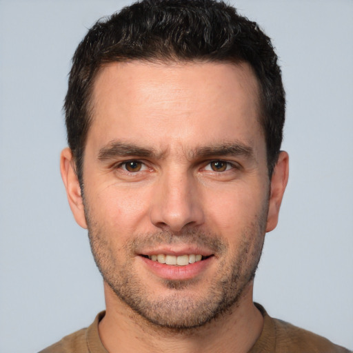 Joyful white young-adult male with short  brown hair and brown eyes