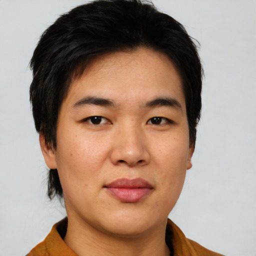 Joyful asian young-adult male with medium  black hair and brown eyes
