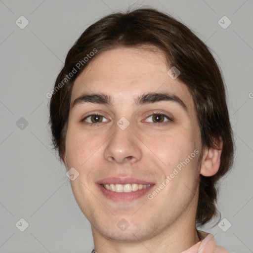 Joyful white young-adult male with medium  brown hair and brown eyes