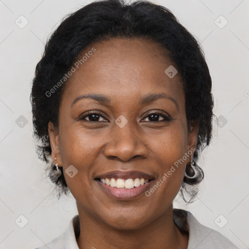 Joyful black adult female with medium  brown hair and brown eyes