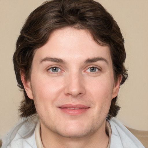 Joyful white young-adult male with medium  brown hair and brown eyes