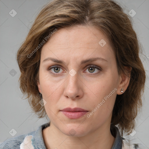 Joyful white adult female with medium  brown hair and grey eyes