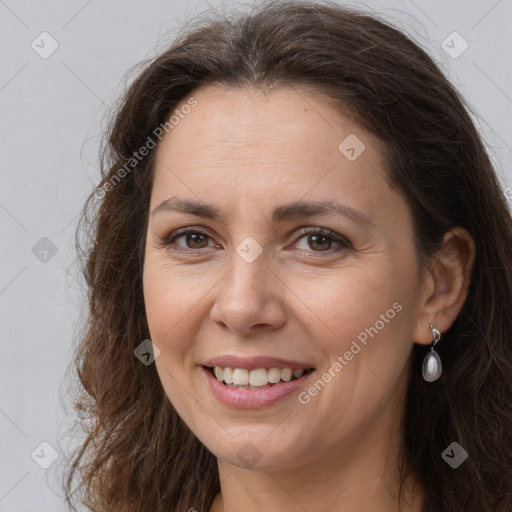 Joyful white adult female with long  brown hair and brown eyes