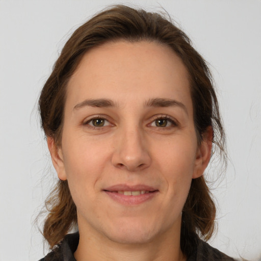 Joyful white adult female with medium  brown hair and brown eyes