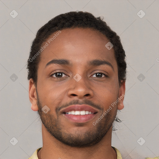 Joyful black young-adult male with short  brown hair and brown eyes