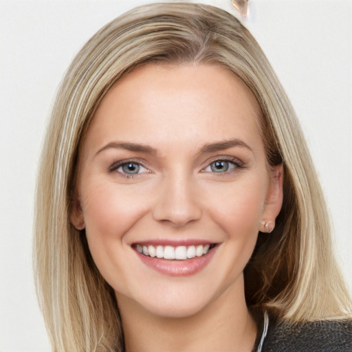 Joyful white young-adult female with long  brown hair and blue eyes