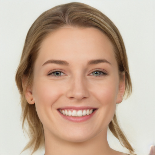 Joyful white young-adult female with medium  brown hair and grey eyes